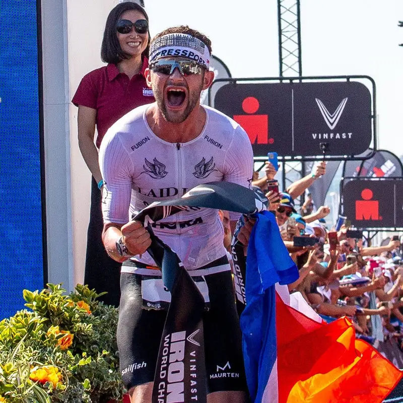 Sam Laidlow celebrating at an Ironman finish line